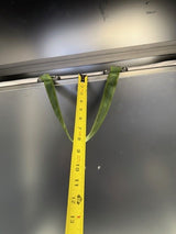 Yellow measuring tape with green strap on a metallic surface