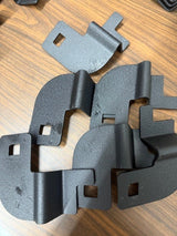 Black metal brackets on a wooden surface
