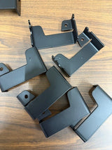 Black metal brackets on a wooden surface
