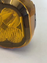 Amber-colored round light on a white background