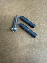 A silver metal hex head screw with a washer and two dark gray plastic sleeve inserts, arranged on a brown textured cardboard background.