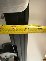 Yellow measuring tape on a metallic surface