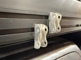 Metal roller shutter brackets on a black background
