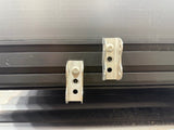 Metal roller shutter brackets on a black background