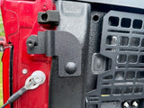 side view of textured black bracket installed on bed post with tailgate down, red truck, pictured provided by customer