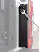 Black bracket installed near truck taillight 