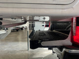 Aluminum colored bracket installed on a truck with a close up of a camper