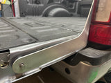 Aluminum bracket installed on truck with bed of truck in background