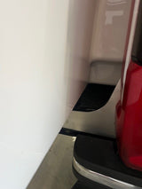 Aluminum colored bracket closeup with taillight and camper 