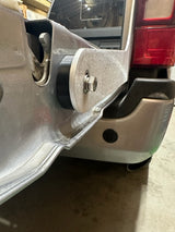 close up of Aluminum bracket installed on truck with tailgate in background