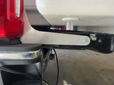 Aluminum bracket installed on truck with bottom of camper visible